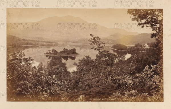 Loch Achray and Ben Venue, View of Loch Achray and Ben Venue, photograph, number: '341, GWW', photographer: George Washington Wilson, Scotland, 1865 - 1880, paper, albumen print, height 116 mm x width 192 mm, landscapes with waters, waterscapes, seascapes (in the temperate zone), mountains, Stirling, Trossachs, Ben Venue, Loch Achray, A sepia-toned landscape photograph showing a calm lake framed by dense foliage in the foreground, with leafy branches and undergrowth partially obscuring the view. Small wooded islands sit in the water, their reflections visible on the lake’s smooth surface. Gentle hills and a large mountain rise in the background beneath a clear sky. On the right shore there is a light-colored building with a steep roof partially visible among trees. Trees along the right edge form a vertical frame, and faint reflections of the shoreline and vegetation appear in the lake.