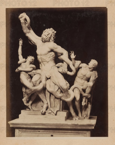 View of the Laocoön group in the Vatican Museums, album page, photograph, This photo is part of an album., inscription: '1330 LAOCOONTE M. Vat.', Vatican Museums, 1870 - c. 1895, photographer, Vatican City, paper, pasteboard, albumen print, height 259 mm x width 200 mm, piece of sculpture, reproduction of a piece of sculpture, Laocoon and his twin sons are strangled by two serpents during the preparations for a sacrifice, A photograph of a marble sculpture showing three male figures entwined with large snakes, each figure displaying tense muscles and expressive faces; the central figure is larger, bearded, leaning back with an arm raised and a contorted expression, while the figures on either side reach and struggle against the snakes that wrap around their limbs and torsos; the sculpture rests on a rectangular plinth with draped cloth carved at its base, set against a dark backdrop and bordered by a lighter mat.