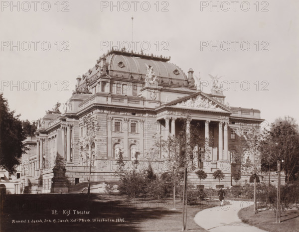 Royal Theater, Wiesbaden, Germany, photograph, View of the Royal Theater, with a park, and a man in uniform in the foreground, Germany., inscription: '112. Kgl. Theater., Mondel & Jacob, Inh. G. Jacob, Hof-Photh. Wiesbaden: 1896.', photographer: Mondel & Jacob, photographer: Mondel, photographer: Julius Jacob, 1896, Hessen, pasteboard, paper, daylight collodion silver print, height 226 mm, width 281 mm x width 330 mm, height 510 mm, A large ornate stone building with a domed roof and decorative sculptures along its roofline and pediments occupies the center of the image, featuring tall columns at its entrance, carved reliefs above the columns, and sculpted figures on ledges and corners; trees and trimmed shrubs stand in front of the building along a curved pathway where a person in a dark coat and light trousers walks, and lamp posts and a stone statue on a pedestal appear near the steps leading up to the building.