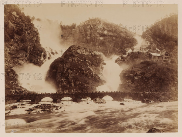 Laatefos, Hardanger, Norway, photograph, Two wild rivers flow from a mountain together into a large river in the foreground, Norway., inscription: 'K. KNUDSEN ...', caption: '8030. LAATEFOS. ODDF ? HARDANGER', photographer: Knud Knudsen, c. 1880 - c. 1900, paper, pasteboard, albumen print, albumendruk, height 163 mm, width 218 mm x width 311 mm, height 396 mm, A wide sepia-toned landscape shows steep rocky cliffs with water cascading down in powerful streams and mist rising where the falls meet the river below, a stone arched bridge crossing the turbulent water in the foreground, and a wooden house with a pitched roof perched on a rocky slope to the right, surrounded by scattered trees and rugged terrain.