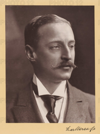 Duke of Marlborough, photograph, Portrait of a man, caption: 'His Grace The Duke of Marlborough, KG', caption: 'Marlborough', caption: 'Lafayette, LTD., Photographers, Copyright, 179, New Bond St., London, W.', photographer: Lafayette Ltd, c. 1890 - c. 1910, pasteboard, paper, carbon print, height 225 mm, width 170 mm x width 263 mm, height 366 mm, A sepia-toned portrait of a man shown from the shoulders up, wearing a suit jacket, a high-collared shirt, and a necktie, with neatly combed hair, a curled mustache, and a clean-shaven face, photographed against a dark background and mounted on a light-colored mat.
