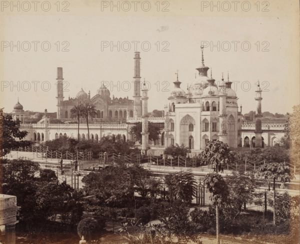 View of mosques in Lucknow, Uttar Pradesh, India, photograph, inscription: 'Lucknow', number: '35', signature: 'Bourne 1051', photographer: Samuel Bourne, c. 1863 - c. 1868, paper, albumen print, height 234 mm x width 284 mm, Oudh, Lucknow, A wide sepia photograph of an ornate building complex with multiple domes and tall slender towers rising above a long crenellated wall, palm trees and dense foliage in the midground and foreground, arched windows and decorative entrances on the nearer structures, domes topped with finials and bulbous crowns, latticework and balustrades along the rooftop edges, paved walkways and fenced pathways weaving through landscaped gardens, lampposts and a few small human figures near the pathways, and a clear sky occupying the upper portion of the image.