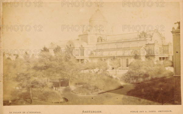 Exterior of the Palace of Industry in Amsterdam, Le palais de l'industrie Amsterdam., photograph, Amsterdam, publisher: Andries Jager, c. 1865 - c. 1880, Andries Jager, photographer, publisher, paper, pasteboard, albumen print, height 90 mm x width 157 mm, temporary exhibition, 'Salon', façade (of house or building), Palace of Industry, A sepia-toned photograph showing a large ornate building with domes and arched windows partially obscured by a park in the foreground. The park contains winding paved paths, planted beds, and many trees with leafy canopies. The building stretches horizontally across the scene with decorative architectural details and rounded roof sections. The image has a faded, aged appearance with light spots and darker edges.