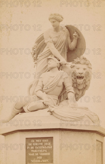 Graaf Adolphus monument in Heiligerlee, photograph, name: 'Fr. Jul von Kolkow court photographer Groningen Groote Markt.', photographer: Friedrich Julius von Kolkow, Heiligerlee, c. 1880 - c. 1900, paper, pasteboard, albumen print, height 157 mm x width 104 mm, Photo in paper cover with description., beasts of prey, predatory animals: lion, monument, statue, dying, Eighty Years' War, Count Adolf Monument, A pale stone sculpture shows a seated armored figure leaning back with one knee bent and a hand resting on a draped cushion, a flowing cloak and detailed armor visible; behind and above this figure stands a robed person with a shield held at their side and one arm extended toward the seated figure, their hair arranged in a braided or sculpted style; beside them a large lion head with an open mouth and visible teeth emerges from the composition; the sculpture rests on a broad pedestal with a rectangular plaque on its face.