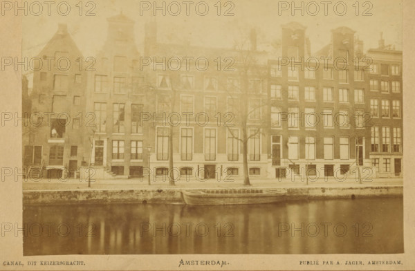 Canal, this Keizersgracht, View of a row of houses on the Keizersgracht in Amsterdam, Amsterdam, cabinet photograph, collector's mark: 'VOSMAER', publisher: Andries Jager, 1860 - 1890, Andries Jager, photographer, publisher, paper, pasteboard, albumen print, height 94 mm x width 135 mm, height 109 mm x width 168 mm, the usual house or row of houses, canals, waters (in city), Keizersgracht, A sepia-toned photograph of a row of narrow multi-story buildings facing a canal with a small wooden boat moored at the water's edge, the buildings featuring tall windows, stepped and ornate gabled roofs, exterior staircases and doors at sidewalk level, leafless trees standing between the sidewalk and buildings, a lamp post near the center, reflections of the buildings and trees visible in the canal water, and a paved sidewalk running along the canal.