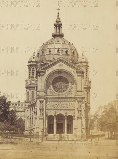 View of a church in Paris (former title), View of the Saint-Augustin Church in Paris, photograph, View of the Saint-Augustin Church (Saint-Augustine) in Paris., Paris, 1867 - 1900, photographer, paper, pasteboard, albumen print, height 320 mm x width 502 mm, church (exterior), Église Saint-Augustin, A large ornate stone building facade topped by a domed roof with a central lantern and cross, flanked by smaller domes and towers, with a prominent circular stained-glass window set into a triangular pediment above sculpted relief panels and arched entrances; the facade features columns, statues in niches, decorative carvings, and balustrades, while the foreground shows a paved open area with lamp posts, fencing, and trees partially visible at the sides, and rows of adjacent buildings lining the street.