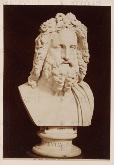 Giove d'Otricoli, Bust of Jupiter, Vatican, album page, photograph, This photo is part of an album., inscription: '1387 - ROMA - Giove d'Otricoli - Museo Vaticano - Anderson', photographer: James Anderson, Vatican Museums, after sculpture by anonymous, c. 1857 - c. 1875, after sculpture by, Vatican City, paper, albumen print, height 411 mm x width 288 mm, piece of sculpture, reproduction of a piece of sculpture, (story of) Jupiter (Zeus), A photograph of a marble bust showing a bearded male head with long wavy hair cascading around the face and onto the shoulders, the facial features carved with closed eyes and a prominent nose and full beard, the torso draped with a cloth over one shoulder, the bust set on a rounded pedestal with decorative molding, all shown against a dark background and framed by a lighter border.