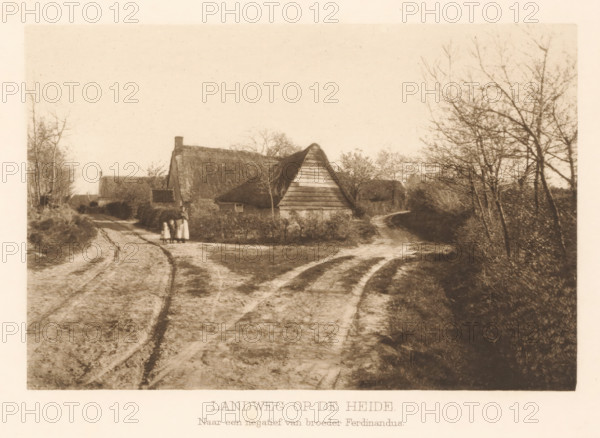 Country road on the heath, View of a country road, page, photomechanical print, photographer: Ferdinandus, Netherlands, cliché maker: anonymous, c. 1900 - in or before 1905, clichémaker, paper, photoaquatint, height 113 mm x width 169 mm, farm or solitary house in landscape, lane, alley, A sepia-toned rural scene showing a dirt path with visible wheel tracks curving toward a cluster of thatched cottages; a triangular wooden gable faces the viewer, surrounded by low hedges and bare trees, with taller trees lining the right edge; three small figures stand near the front hedge beside the path; the sky is empty and light, and the overall image has a grainy, aged appearance.