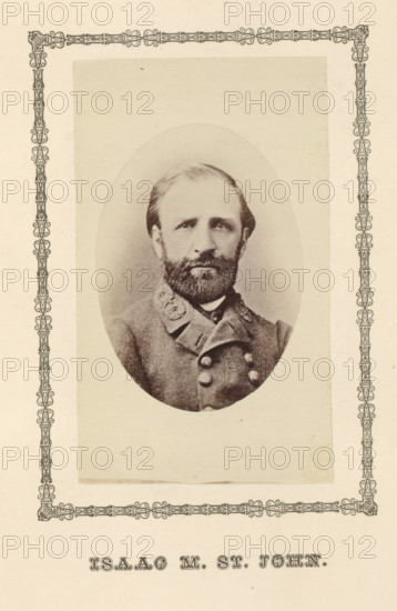 Isaac M. St. John, photograph, page, c. 1876 - in or before 1881, photographer, paper, albumen print, height 100 mm x width 60 mm, Person, Isaac Munroe St. John, officer, A faded oval photographic portrait of a bearded man wearing a double-breasted uniform jacket with decorative collar details, mounted on a rectangular sheet with an ornate decorative border around the photo area.