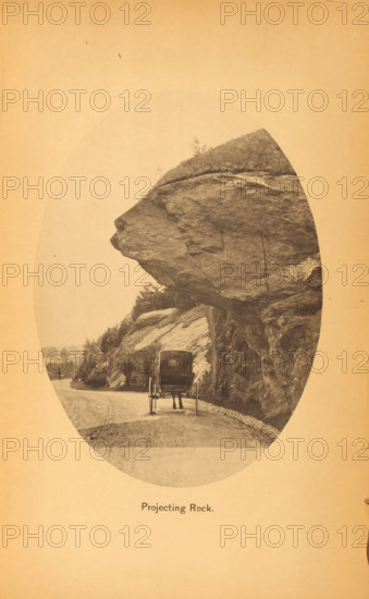 Projecting rock, page, photomechanical print, New York (city), c. 1866 - in or before 1871, North America, paper, collotype, photoprint, height 160 mm x width 116 mm, Print after page 157., public road, four-wheeled, animal-drawn vehicle, eg: cab, carriage, coach, rock-formations, A sepia-toned oval photograph shows a dirt road curving beside a large rock face with a massive overhanging ledge protruding above the roadway; beneath the ledge a horse-drawn carriage faces away from the viewer with the horse partially visible and the carriage wheels and rear seen; the rock surface displays rough textures and strata with vegetation and small shrubs on top and along the slope; the road edge is lined with small stones and the distant background shows faint trees and landscape.