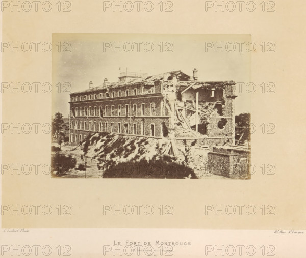 Le Fort de Montrouge. Casernes and ruins, View of the remains of a barracks of Fort de Montrouge in Arcueil after the destruction by the Paris Commune, photograph, page, number: '(No. 81)', address: '31, Rue St. Lazare', photographer: Alphonse-Justin Liébert, Arcueil, 1871 - 1872, paper, albumen print, height 99 mm x width 136 mm, barracks, ruin of a building, architecture, fortress, Paris Commune (1871), Fort de Montrouge, A sepia-toned photograph shows a large multi-story stone building with many rectangular window openings along its facade, the right side of the building heavily damaged with collapsed floors and exposed wooden beams and rubble, a sloped embankment in front of the structure with scattered vegetation, fragments of masonry and timbers piled at the base, a few small trees and bushes near the building, and a pale sky above.