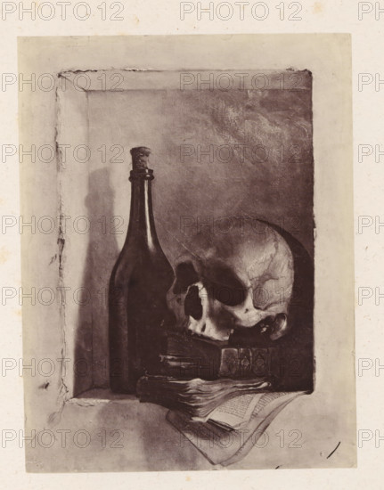 Photo reproduction of Death's Head by Antoine Wiertz, photograph, reproduction, page, check stamp: 'SOCIÉTÉ ROYALE BELGE DE PHOTOGRAPHIE, 69, RUE KEYENVELD, BRUXELLES', photographer: Edmond Fierlants, after painting by Antoine Joseph Wiertz, c. 1863 - in or before 1868, Edmond Fierlants, Antoine Joseph Wiertz, photographer, after painting by, paper, albumen print, height 151 mm x width 115 mm, death's head, skull (symbol of Death), A shaded rectangular niche contains a tall dark bottle with a narrow neck and a cork, positioned beside a human skull resting on a stack of worn books, with an open folded book placed below them; the interior of the niche shows textured, slightly cracked surfaces and soft shadows, while the outer border of the image is a lighter, uneven frame with small stains and discolorations.