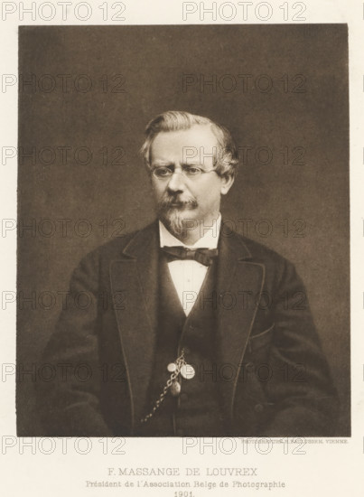 F. Massange-de Louvrex, Portrait of Ferdinand Massange-de Louvrex, page, photomechanical print, inscription: 'Président de l'Association Belge de Photographie, 1901', maker: Richard Paulussen, c. 1897 - in or before 1902, Richard Paulussen, paper, photoaquatint, height 122 mm x width 99 mm, Print two pages before page 224., Person, Ferdinand Massange - the Louvrex, historical persons, adult man, A sepia-toned portrait of a middle-aged man seated against a plain dark background, wearing round spectacles and a neatly trimmed mustache and goatee, his hair combed to the side with a slight wave; he is dressed in a dark suit jacket over a waistcoat and white shirt with a bow tie, and a pocket watch chain with attached fobs hangs from his waistcoat.