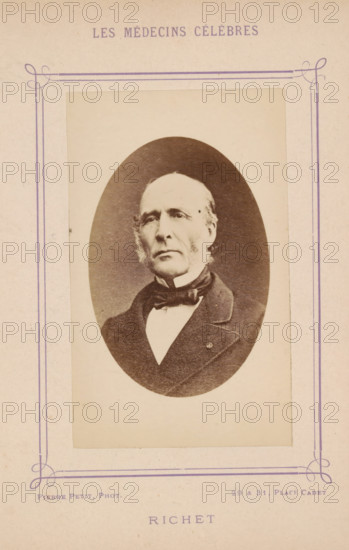 Portrait of Alfred-Louis-Dominique Richet, Richet, photograph, page, inscription: '(Publication de la Revue de literature médicale du, No.', photographer: Pierre Petit, c. 1871 - c. 1879, paper, albumen print, albumendruk, height 91 mm x width 57 mm, Person, Alfred-Louis-Dominique Richet, historical persons, adult man, An oval sepia photograph of an older man mounted on a pale rectangular card with decorative purple border lines and corner flourishes, showing the man from the chest up wearing a dark coat, a high white collar, and a bow tie, with light-colored hair combed back and muttonchop sideburns, a serious facial expression, and a plain light background within the oval.