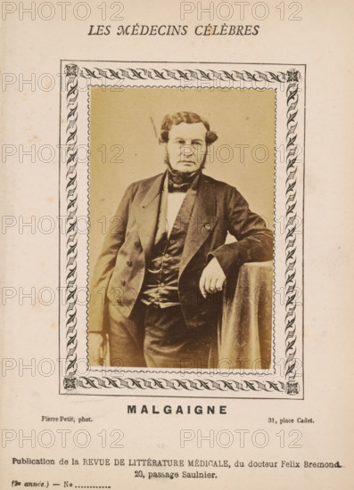 Malgaigne, Portrait of Joseph-François Malgaigne, photograph, page, inscription: '(Publication de la Revue de literary médicale, du docteur Félix Bremond, 20, Passage Saulnier, Paris., 3e année - No.', photographer: Pierre Petit, c. 1871 - c. 1879, paper, albumen print, height 89 mm x width 56 mm, Person, Joseph-François Malgaigne, historical persons, adult man, A sepia-toned portrait of a man with muttonchop sideburns and a formal dark suit, standing with one arm resting on a draped surface, framed by a decorative border with a repeating leaf motif; the image shows the man's jacket, waistcoat, bow tie, and a visible ring on his hand, set against a plain backdrop and mounted on aged paper with faint spots and discoloration.