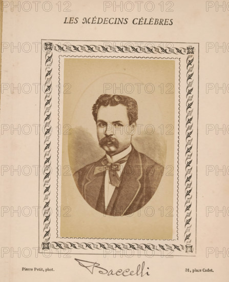 Photo reproduction of a portrait of Guido Baccelli, photograph, reproduction, page, annotation: 'Paracelse', number: '78', inscription: 'Publication de la Revue de literature médicale, du docteur Felix Bremond, 20, Passage Saulnier, 4e année.) - No.', photographer: Pierre Petit, after design by anonymous, c. 1871 - c. 1879, paper, albumen print, height 81 mm x width 51 mm, Person, Guido Baccelli, historical persons, adult man, A sepia-toned printed portrait of a man with wavy hair and a thick mustache, shown waist-up inside an oval frame; he wears a jacket with a visible lapel, a shirt with a high collar, and a wide bow at the neck. The oval portrait is set on a rectangular beige background surrounded by an ornate border with a repeating leaf-and-scroll pattern and a scalloped inner edge. The page has a light cream color and shows slight age spotting and wear.