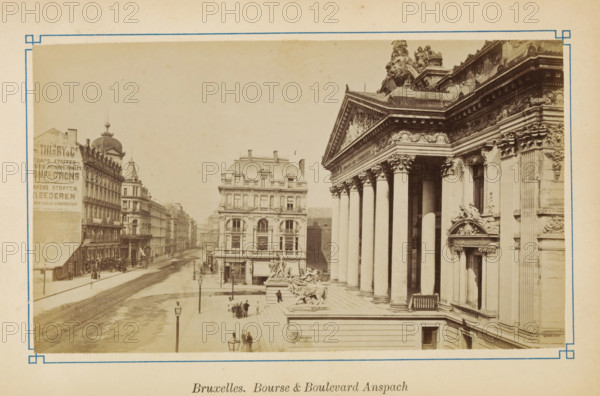 View of the Anspachlaan and the stock exchange in Brussels, Bruxelles. Bourse & Boulevard Anspach, photograph, page, Boulevard Anspach, c. 1875 - c. 1880, photographer, Brussels, paper, albumen print, height 101 mm x width 175 mm, avenue, boulevard, promenade, esplanade (city(-scape) with figures, staffage), Exchange, Bourse, Beurs (Brussels), A sepia-toned street scene showing a broad boulevard flanked by multi-story buildings and a grand neoclassical building with tall columns and ornate carved decorations, including sculpted figures and a large sculpted lion near the roofline; stone steps lead up to the neoclassical entrance where groups of people stand on the sidewalk and near a sculptural fountain featuring reclining figures and horses; the boulevard extends into the distance with tram tracks visible on the road and lampposts along the pavement, while the opposite side features rows of buildings with decorative rooftops and a domed tower.