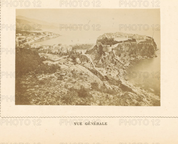 View of Monte Carlo in Monaco, Vue Générale, photograph, page, Monte Carlo, c. 1873 - in or before c. 1878, photographer, paper, albumen print, height 59 mm x width 88 mm, prospect of city, town panorama, silhouette of city, A sepia-toned aerial view shows a coastal landscape with rugged cliffs descending to a calm sea, a fortified structure perched atop a promontory with visible walls and towers, clusters of buildings and roads nestled among trees on the slopes, a bay curving into the distance with low hills along the shoreline, and areas of vegetation and rocky terrain in the foreground.