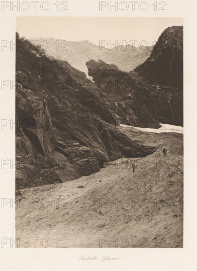 Suphelle-Glacier, View of the Supphellebreen, page, photomechanical print, number: '29', photographer: Paul Lange, Sogn og Fjordane, cliché maker: Richard Paulussen, Vienna, c. 1888 - in or before 1893, Lower Austria, paper, collotype, photoprint, height 198 mm x width 144 mm, glacier (landscape with figures, staffage), A sepia-toned photograph showing a rocky mountain landscape with steep, jagged cliffs and textured rock faces. In the middle distance a darker rock formation rises between lighter ridges, with a narrow cascade of water running down a crevice and a patch of lighter snow or ice near the base. Vegetation appears as darker foliage along the left upper slope. In the foreground a rough, uneven expanse of rock leads toward the cliffs, and a small human figure stands near the right edge of the rock foreground holding a long object. The sky above the ridgeline is pale and clear.