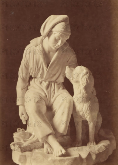 Sculpture of a boy and a dog by Leopold Borbone, photograph, This photograph is part of a cover with 18 photographs on 18 sheets and 14 text sheets., photographer: Grillet jeune, c. 1854 - in or before 1859, paper, albumen print, height 162 mm x width 115 mm, piece of sculpture, reproduction of a piece of sculpture, boy (child between toddler and youth), dog, A sepia-toned photograph of a seated statue depicting a person wearing a loose garment and a soft cap, head tilted downward and gazing toward a dog sitting beside them, the dog looking up at the person; the person’s bare feet rest on a textured base and a small basket and coiled object sit near their feet; the scene is set against a dark rectangular background framed by multiple light and dark borders on a light paper mount.