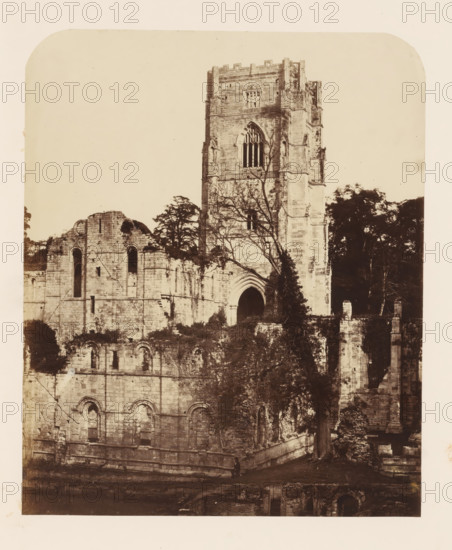 East side of the Fountains Abbey near Ripon, photograph, page, photographer: Joseph Cundall, Fountains Abbey, photographer: Philip Henry Delamotte, c. 1851 - in or before 1856, Yorkshire, Studley Royal Park, paper, albumen print, height 268 mm x width 221 mm, ruin of church, monastery, A sepia-toned photograph of a large stone ruin showing a tall rectangular tower with battlements and a large arched window, adjacent sections of crumbled walls with arched openings and layered masonry, trees and climbing vegetation growing around and in front of the structure, a prominent arched doorway partially obscured by branches, scattered stonework and foundations at ground level, and a lone small figure standing near the base of the wall.