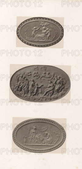 Bas-reliefs of Psyche being bound by putti, a feast of the gods and friendship comforting sorrow, photograph, page, photographer: Joseph Cundall, c. 1868 - in or before 1873, paper, carbon print, height 361 mm x width 270 mm, Friendship, 'Amicitia' (Ripa), sculpture (relief, sculpture), banquets, feasts of the gods (in general), other scenes from the story of Cupid and Psyche (aggressive, unfriendly activities and relationships), A vertical sheet shows three oval relief plaques mounted one above another, each with a decorative border and classical figures in low relief; the top plaque depicts a seated robed woman with two small winged children beside her and a child reaching toward a leafy branch above, set against a plain background with a patterned rim; the middle plaque shows a crowded scene of many draped and partially draped figures in dynamic poses, some seated and some standing, with reclining figures and a sense of layered depth and cloudlike forms at the lower edge; the bottom...