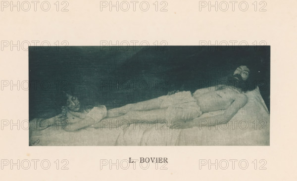 Woman, presumably Mary Magdalene, embraces the feet of the dead body of Christ, Sentiment d'Art en Photographie, photomechanical print, This print is part of 8 covers with 22 text sheets and 89 prints on loose sheets in and between the covers., number: 'Vol. 1, No 4, Planche 1.', photographer: Léon Bovier, clichémaker: anonymous, printer (person): Liorel & Cie., c. 1894 - in or before 1899-01, Léon Bovier, Liorel & Cie., photographer, clichémaker, printer (person), paper, collotype, photogravure, height 87 mm x width 210 mm, Christ's feet are anointed by Mary (Magdalene), A rectangular monochrome image centered on a pale background shows a horizontal scene of a bed with a naked adult male figure lying on his back on the right side and a separate smaller female figure lying on the left side near his feet; the male has a beard and dark hair, his torso and limbs are exposed and he rests on a pillow, while the smaller figure appears partially covered by fabric and rests with her head turne...