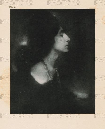 Portrait of an unknown woman, page, photomechanical print, inscription: 'US. V.', inscription: 'La bella by Eduard J. Steichen', photographer: Edward Steichen, cliché maker: anonymous, c. 1900 - in or before 1905, paper, two-color autotype, height 137 mm x width 111 mm, historical persons - BB - woman, A grainy black and white portrait of a woman in profile showing her head, neck, and shoulder against a dark background, with her hair dark and framing her face, her eyes closed, her lips slightly parted, and a beaded necklace draped around her neck and over her shoulder.