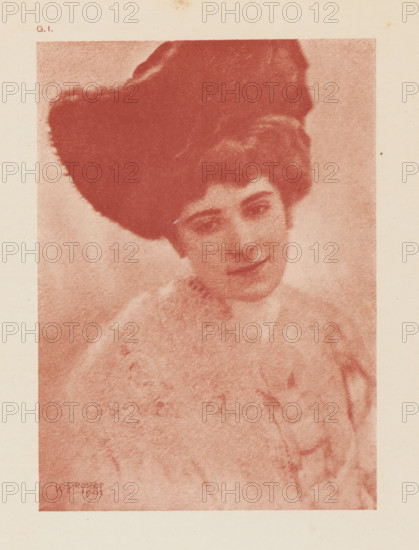 Portrait study of an unknown woman, page, photomechanical print, inscription: 'GI', inscription: 'Portrait study b Karl Prokop', photographer: Karl Prokop, cliché maker: anonymous, c. 1900 - in or before 1905, paper, autotypie, height 152 mm x width 110 mm, historical persons - BB - woman, A faded monochrome portrait of a woman with a large dark hairpiece and softly curled hair, her head tilted slightly and eyes looking downward, wearing a light-colored, textured garment with a high collar; the image has a grainy, sepia-toned appearance and is framed by a pale border.