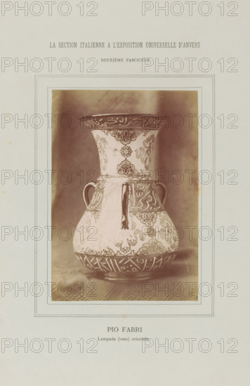 Decorated vase, Pio Fabri - Lampada (vaso) orientale, La Section Italienne a l'Exposition Universelle d'Anvers - Deuxième Fascicule, photograph, page, c. 1880 - in or before 1885, photographer, paper, albumen print, height 138 mm x width 95 mm, Photo on loose plate opposite page 36., container of ceramics: jar, jug, pot, vase, A sepia-toned photograph of a decorative vase centered within a bordered page, showing a flared neck, rounded body, two small looped handles, and a vertical spout-like projection from the neck area; the vase surface is covered in intricate repeating floral and geometric patterns and ornate bands around the neck and base, with contrasting darker decorative motifs against a lighter background; the vase rests on a textured cloth and is framed by multiple thin rectangular lines on the page.