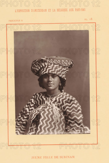 Jeune fille de Surinam, Portrait of probably Wilhelminia van Ede, page, photomechanical print, inscription: 'Fascicule II, PL. 18', photographer: attributed to Photographie Française (Amsterdam), cliché maker: anonymous, c. 1878 - in or before 1883, Attributed to, paper, Woodburytype, height 138 mm x width 100 mm, Person, Wilhelminia van Ede, historical persons - BB - woman, World Exhibition 1883 (Amsterdam), A sepia portrait of a young woman centered on a pale bordered page, wearing a patterned headwrap and matching garment with bold wavy stripes, a beaded necklace, earrings, and a calm facial expression, photographed against a plain darker backdrop.