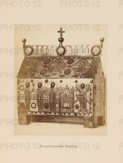 Byzantine reliquary in the form of a sarcophagus, photograph, page, inscription: 'No. 159. Reliquaire Byzantin', photographer: Anselm Schmitz, c. 1871 - in or before 1876, paper, albumen print, height 125 mm x width 105 mm, sarcophagus, relics (and reliquaries), A photograph shows a rectangular ornate box with a sloped lid, raised on short carved legs, covered in decorative panels and medallions; the lid top has circular motifs and a frieze with rounded cutouts topped by a central finial with a small cross and spherical knobs at the corners; the front panel displays standing robed figures, circular ornaments, and a scene with an arched element and a seated winged figure, all rendered in a stylized carved and inlaid manner, with patterned borders along the edges.