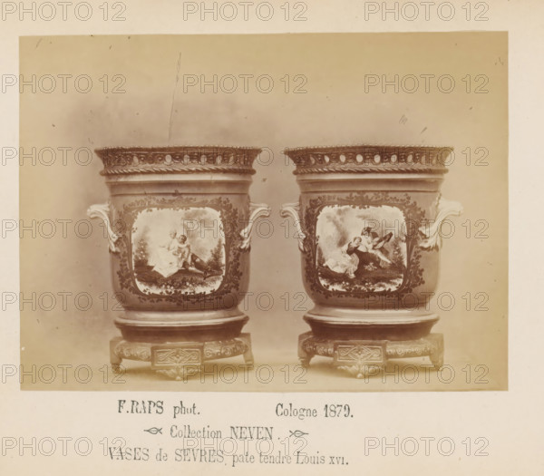 Two Sèvres vases of soft porcelain, photograph, page, inscription: 'Collection NEVEN, Vases de Sevres, pate tendre Louis XVI.', photographer: Friedrich Raps, Cologne, 1879, North Rhine-Westphalia, paper, albumen print, height 105 mm x width 142 mm, vase, ornament, A sepia-toned photograph showing two ornate ceramic vases placed side by side on decorative square stands, each vase featuring scroll-shaped handles and a decorative openwork rim, painted panels on their fronts depicting scenes with figures in classical dress set in landscapes, floral and foliate ornament surrounding the panels, and carved detailing on the wooden or metal stands beneath them.