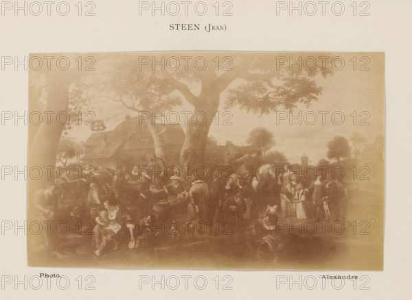 Photo reproduction of Village Festival in Warmond by Jan Steen, photograph, reproduction, page, inscription: 'Steen (Jean)', photographer: Alexandre, after painting by Jan Havicksz. Steen, c. 1878 - in or before 1883, paper, albumen print, height 90 mm x width 150 mm, festivities, village (city(-scape) with figures, staffage), Warmond, A sepia-toned reproduction of a painting mounted on a cream background, showing a village scene with large trees with spreading branches in the foreground, a thatched-roof cottage partially visible behind the trees, and numerous small figures gathered beneath and around the trees engaged in various activities. The figures include adults and children in period clothing, some seated and some standing, with a few animals such as dogs and a horse visible among them. The scene extends into a distant landscape with more trees and a small tower or steeple on the horizon. The mounted image has a narrow border and is centered on the page.