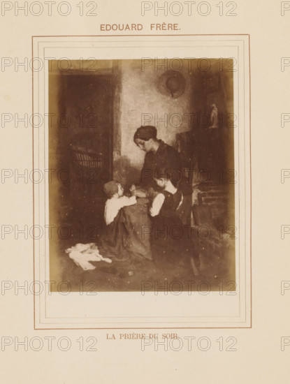 La prière du soir, Photo reproduction of La prière du soir by Pierre Edouard Frère, photograph, reproduction, page, inscription: 'Edouar Frère', after painting by Pierre Edouard Frère, c. 1878 - in or before 1883, photographer, paper, albumen print, albumendruk, height 120 mm x width 97 mm, mother and child(ren), woman and child(ren) (family group), painting, drawing and the graphic arts, A sepia-toned framed image shows a seated woman with her head bowed and two children kneeling beside her, the woman wearing a dark dress and headscarf and the children in simple clothing; they are positioned in a dim interior with a rough wall behind them, a small statue on a shelf to one side, and a pile of cloth on the floor in front.