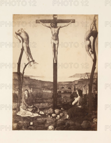 Photo reproduction of the Crucifixion of Christ by Antonello da Messina, photograph, reproduction, page, photographer: Edmond Fierlants, after painting by Antonello da Messina, publisher: C. Muquardt, Brussels, c. 1856 - in or before c. 1861, paper, albumen print, albumendruk, height 370 mm x width 269 mm, crucified Christ, with particular persons under the cross, A sepia-toned depiction of a crucifixion scene framed by a pale border, showing a central wooden cross with a male figure suspended, arms outstretched and a cloth around his waist, flanked by two other wooden supports each bearing a male figure in contorted poses with minimal clothing. Below the crosses, a rocky foreground contains scattered skulls and stones, and two seated women in long draped garments face the central cross, one with hands clasped and the other looking downward. In the middle distance there is a gently rolling landscape with buildings and a coastline visible under a soft, light sky.