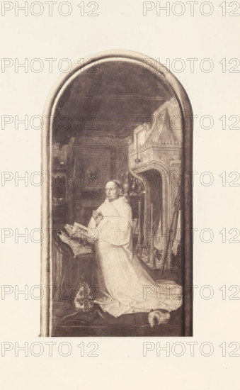 Photo reproduction of Christiaan de Hondt, abbot of Ter Duinen, photograph, reproduction, page, photographer: Edmond Fierlants, after painting by anonymous, publisher: C. Muquardt, Brussels, c. 1856 - in or before c. 1861, paper, albumen print, albumendruk, height 317 mm x width 168 mm, monk(s), friar(s), one person praying, A tall, narrow arched panel shows a robed figure kneeling in front of an open book on a lectern, hands clasped in a prayer gesture and gaze directed slightly upward; the figure wears a flowing light-colored robe with a long train spread on the floor and a cap placed near the feet. To the right of the figure is an ornate carved fireplace with decorative mantelshelf details and a set of andirons and tools leaning nearby, while behind and above the figure shelves, drapery, and architectural moldings are visible in dim tones. The scene is rendered in muted monochrome tones and framed by a rounded arch border with a plain lighter background surrounding the panel.