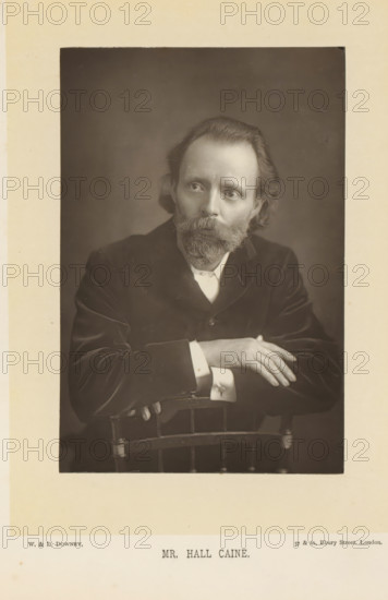 Portrait of Hall Caine, Mr. Hall Caine, page, photomechanical print, inscription: '57 & 61, Elbury Street, London.', photographer: Downey, William & Daniel, London, cliché maker: anonymous, c. 1882 - in or before 1892, paper, Woodburytype, height 140 mm x width 93 mm, Person, Hall Caine, portrait of a writer, A sepia portrait of a man seated behind the back of a wooden chair, shown from the torso upward, wearing a dark jacket and a light shirt with visible cuffs, his hands resting on the top of the chair with fingers relaxed, a full beard and mustache, shoulder-length hair swept back, and a neutral facial expression as he gazes slightly away from the camera, set against a plain dark background and surrounded by a lighter matte border.