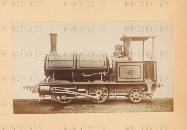 Steam locomotive made by Sharp, Stewart and Company, photograph, page, number: '751', inscription: 'Class 751. Tank engine, for Mixed Traffic.', c. 1874 - in or before 1884, photographer, paper, albumen print, height 81 mm x width 141 mm, steam locomotive, A sepia-toned studio photograph of a vintage steam locomotive shown in profile, with a tall straight chimney rising from a cylindrical boiler that has riveted panels and decorative framed edges, an exposed set of driving wheels with connecting rods and visible mechanical linkages beneath the boiler, a small open cab with a canopy roof and control fittings including valves and pipes, a rectangular side panel on the cab with a framed border, buffer fixtures at the front and rear, and the locomotive positioned on a short section of track against a plain light background with a textured mounting border around the image.