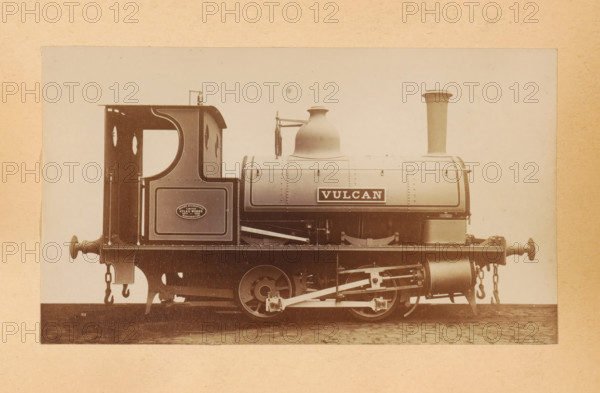 Steam locomotive made by Sharp, Stewart and Company, photograph, page, inscription: 'Classes 627 and 822. Tank shunting engines.', number: '915', c. 1874 - in or before 1884, photographer, paper, albumen print, height 84 mm x width 144 mm, steam locomotive, A sepia-toned photograph of a vintage steam locomotive shown in profile, with a boxy cab at the rear featuring rounded window openings and decorative paneling, a cylindrical boiler with a smooth rounded dome and a tall straight chimney toward the front, visible riveted seams and banding along the boiler, external pipework and a vertical injector assembly beside the dome, a narrow running board along the side, exposed driving wheels and connecting rods beneath the boiler, leaf springs and suspension components, buffing gear and chains hanging from both ends of the frame, and the locomotive set against a plain light background with a textured border surrounding the image.