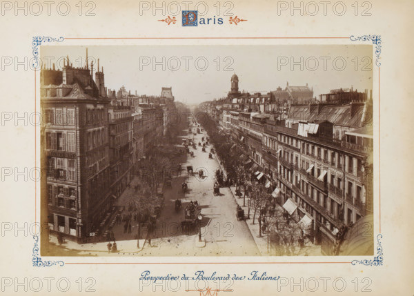 View of the Boulevard des Italiens in Paris, Perspective du Boulevard des Italiens, photograph, page, number: '52', Paris, c. 1879 - c. 1889, photographer, paper, albumen print, albumendruk, height 120 mm x width 188 mm, four-wheeled, animal-drawn vehicle, eg: cab, carriage, coach, avenue, boulevard, promenade, esplanade, Boulevard des Italiens, A sepia photograph centered on a wide city boulevard flanked by tall multi-story buildings with mansard roofs, chimneys, and rows of windows and awnings, showing tree-lined sidewalks and a variety of horse-drawn carriages and vehicles moving along the street; pedestrians are visible on sidewalks and at street corners, some clustered near building entrances, while streetlamps and a few freestanding signs punctuate the avenue; in the distance a domed clock tower and other roofline structures rise above the rooftops, and decorative border designs frame the photograph against a pale, slightly mottled background.
