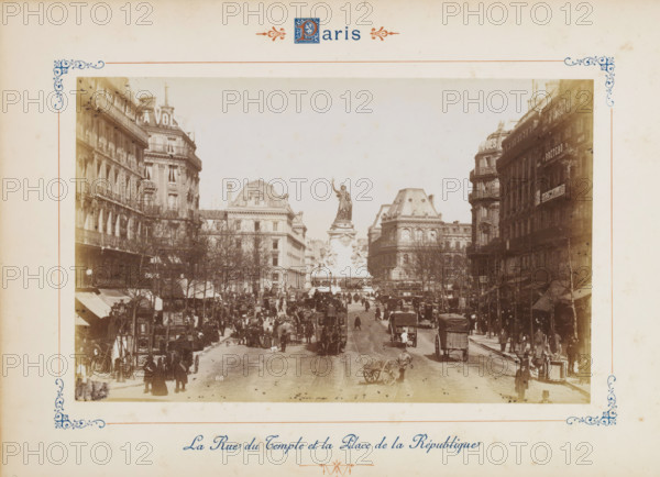 Colonne de Juillet, View of the Colonne de Juillet on the Place de la Bastille in Paris, photograph, page, number: '143', Paris, c. 1879 - c. 1889, photographer, paper, albumen print, albumendruk, height 188 mm x width 120 mm, square, circus, column, pillar, architecture, A sepia-toned street scene framed by a decorative border shows a wide city avenue flanked by tall multi-story buildings with ornate facades and mansard roofs; a large sculpted monument with a standing female figure atop a pedestal is visible in the distance at the center of the composition; the street is busy with horse-drawn carriages, carts, and many pedestrians walking along sidewalks and crossing the road, while leafless trees line the sidewalks and awnings and street lamps project from the building fronts.