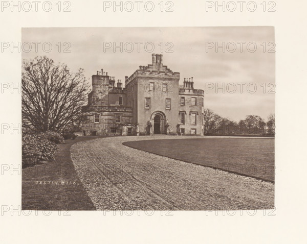 Castlemilk, photograph, page, photographer: Thomas Annan, Glasgow, c. 1868 - in or before 1878, paper, carbon print, height 115 mm x width 160 mm, rural housing, eg country-house, villa, cottage, façade (or house or building), Castlemilk House, A sepia-toned photograph showing a large stone building with a central entrance framed by an arched doorway and rectangular windows, a curved gravel driveway leading toward the entrance, a trimmed lawn adjacent to the driveway, a large bare-branched tree to the left of the building, lower shrubbery near the tree, and a distant line of trees along the horizon under a cloudy sky.