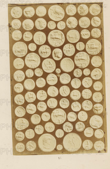 Antique medals, photograph, page, name: 'A. Cadart 3. Rue St. Fiacre Paris Editeur', number: '11', Rome, c. 1849 - in or before 1859, photographer, paper, albumen print, height 200 mm x width 126 mm, medal (considered as a piece of sculpture, regardless of its specific function), A rectangular panel filled with many round, raised medallions arranged in rows against a darker background, each medallion showing low-relief profiles, animals, chariots, and various figurative scenes; the medallions vary in size and display carved faces in profile, horses, riders, standing figures, and animals, with some circular impressions showing wreaths or decorative borders, all set within a light tiled area bordered by a lighter margin.