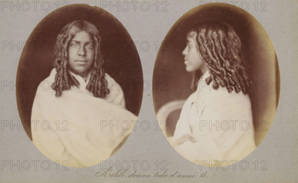Kebili, donna toda d'anni 15, Two portraits of Kebili of the Toda tribe, photograph, page, photographer: Paolo Mantegazza, India, c. 1881 - in or before 1886, Paolo Mantegazza, photographer, paper, albumen print, height 151 mm x width 241 mm, adolescent, young woman, maiden (sideview, profile), maiden (front view), A sepia-toned double portrait showing the same young person in two oval frames side by side, one a front-facing view and the other a profile. The person has long, tightly curled or twisted hair falling past the shoulders and a neutral facial expression in the front view while the profile shows a slightly turned head. They are wrapped in a light-colored draped garment that covers the shoulders and chest. The ovals sit on a plain, grayish mount with a small area of handwritten text visible below the images. The background inside the ovals is dark, creating contrast with the subject and the light garment.