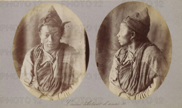 Two portraits of a Tibetan lama, Lama tibetano d'anni 30, photograph, page, photographer: Paolo Mantegazza, Tibet, c. 1881 - in or before 1886, Paolo Mantegazza, photographer, paper, albumen print, height 151 mm x width 241 mm, adult man (side view, profile), adult man (front view), priest, Hinduism, Buddhism, Jainism, Two oval sepia portraits of the same person are mounted on a grey background; in the left portrait the person faces forward with a neutral expression, wearing a pointed cap with a textured band, circular earrings, draped layered clothing, and a long beaded necklace, while in the right portrait the person is shown in profile facing to the side wearing the same cap, earrings, layered garments, and beads, with hands resting in front and a soft, mottled backdrop behind both images.