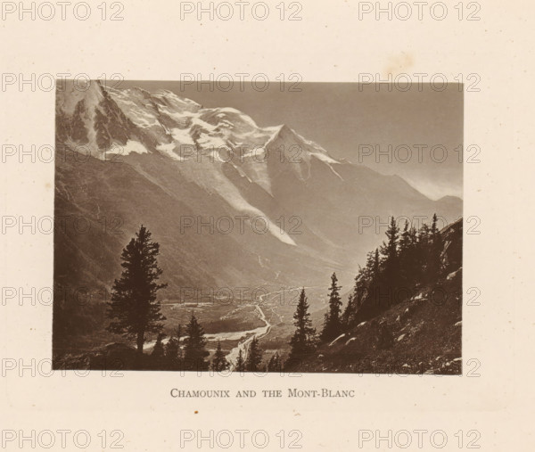 Chamounix and the Mont-Blanc, View of Chamonix and the Mont Blanc, page, photomechanical print, Chamonix, c. 1874 - in or before 1884, paper, collotype, photoprint, height 92 mm x width 129 mm, city-view in general, 'veduta', mountains, Mont Blanc, A sepia-toned landscape photograph shows a mountain range with snow patches on jagged peaks and steep slopes, a valley below with a winding river visible as a lighter ribbon, and dark silhouettes of tall evergreen trees in the foreground on a rocky hillside, all framed by a light textured border.