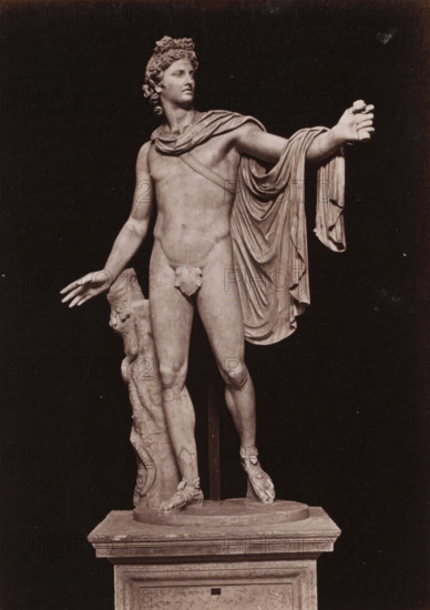 Apollo Belvedere in the Vatican Museums, photograph, page, Vatican Museums, c. 1850 - in or before 1860, photographer, Vatican City, paper, albumen print, height 134 mm x width 96 mm, (story of) Apollo (Phoebus), A photograph of a marble statue of a nude male figure standing on a rectangular plinth, shown against a dark background; the figure has curly hair and a composed facial expression, a draped garment over one shoulder and arm that falls in folds, an outstretched arm with an open hand, and the opposite arm relaxed with fingers extended; a leafy covering adorns the groin area, one leg is slightly forward with the foot wearing a detailed sandal, and a carved support column with decorative elements stands beside the figure, resting on the round base atop the plinth.