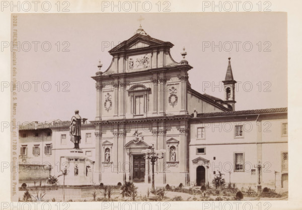 Firenze. Facciata della chiesa di S. Marco, opera del 1780 di Giovacchino Pronti, Facade of the San Marco Monastery in Florence, photograph, page, number: '3028.', photographer: Fratelli Alinari (possibly), Florence, c. 1877 - in or before 1887, Tuscany, paper, albumen print, height 98 mm x width 145 mm, Photo on frontispiece., facade (of house or building), San Marco, A sepia-toned photograph of a classical church façade with ornate architectural details including columns, pilasters, sculpted reliefs, and decorative wreath motifs, a central arched doorway with carved panels, niche statues set into the façade, and a pedimented upper section topped with finials; a bell tower with a pointed roof appears to the side; in front of the church a raised statue on a pedestal overlooks a fenced garden area with small plants and pathways, and a decorative streetlamp stands near the entrance; adjacent buildings with shuttered windows flank the church.
