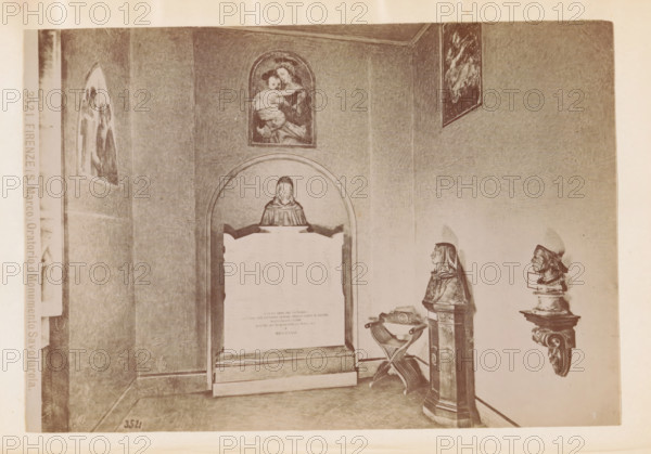 Firenze (S. Marco) Oratorio e Monumento Savonarola, Oratory in the San Marco Monastery in Florence with a monument to Girolamo Savonarola, photograph, page, number: '3521', San Marco, c. 1880 - in or before 1890, photographer, Florence, Tuscany, paper, albumen print, height 100 mm x width 145 mm, monument, statue, abbey, monastery, convent, Roman Catholic church, interior, representation of a building, A sepia-toned interior scene showing a corner of a room with framed religious paintings on the walls and sculpted busts on pedestals; a central arched niche contains a rectangular stone monument topped by a small bust wearing a hood, above the niche a painting of a mother holding a child is hung; to the right a bust on a tall pedestal and a carved wall-mounted head are visible, with a folding wooden chair and an ornate basin placed near the monument; the walls and floor show subtle texture and shading and the overall lighting is soft and diffuse.